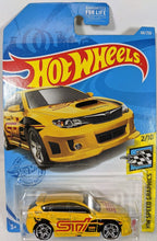 Load image into Gallery viewer, Just in case you didn&#39;t know-the WRX stands for World Rally eXperimental. This sporty little car really looks like it has a stiffer suspension and tight handling. Has a sharp white red and black livery with a large graphic STI on the side. Car 2 of 10 in the HW Speed Graphic group.   GTB98-M9C0L
